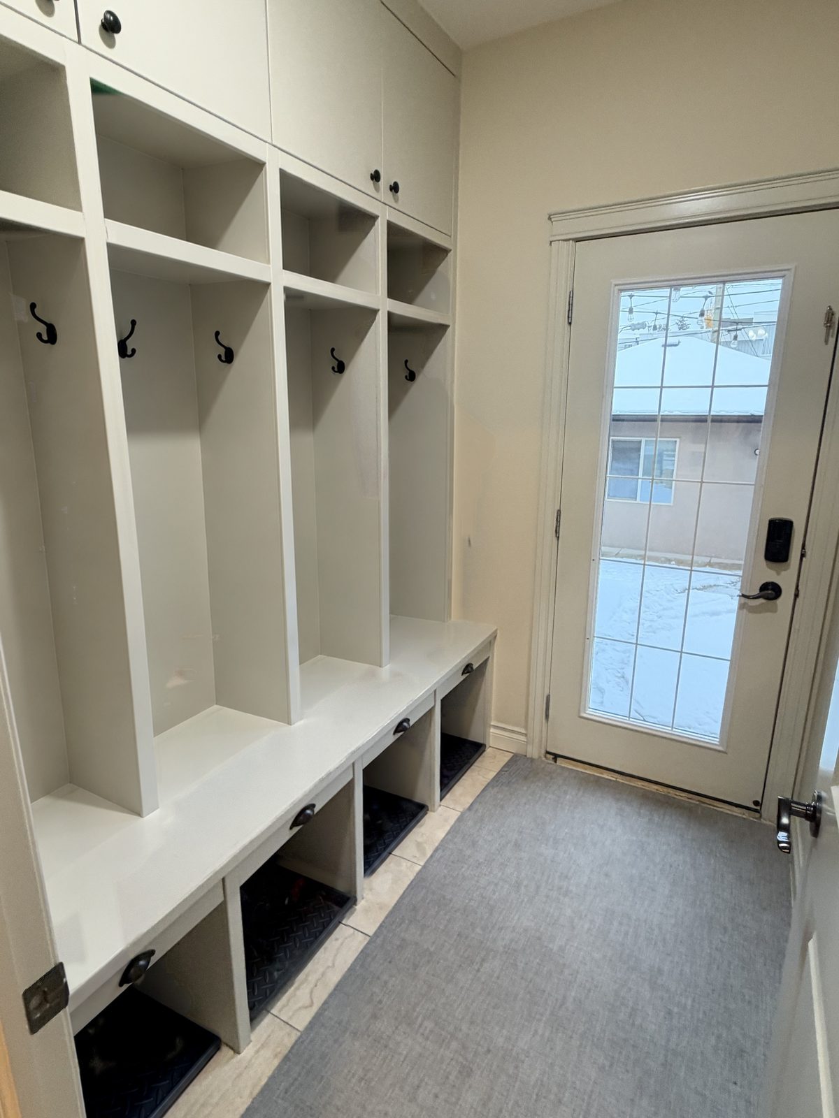 Mudroom with built-in lockers and bench by the back door