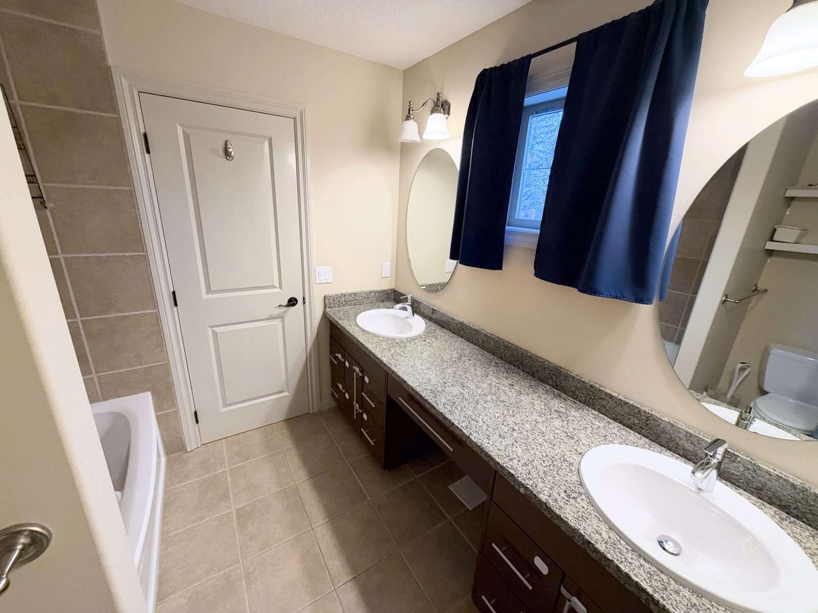Bathroom with double vanity and tub