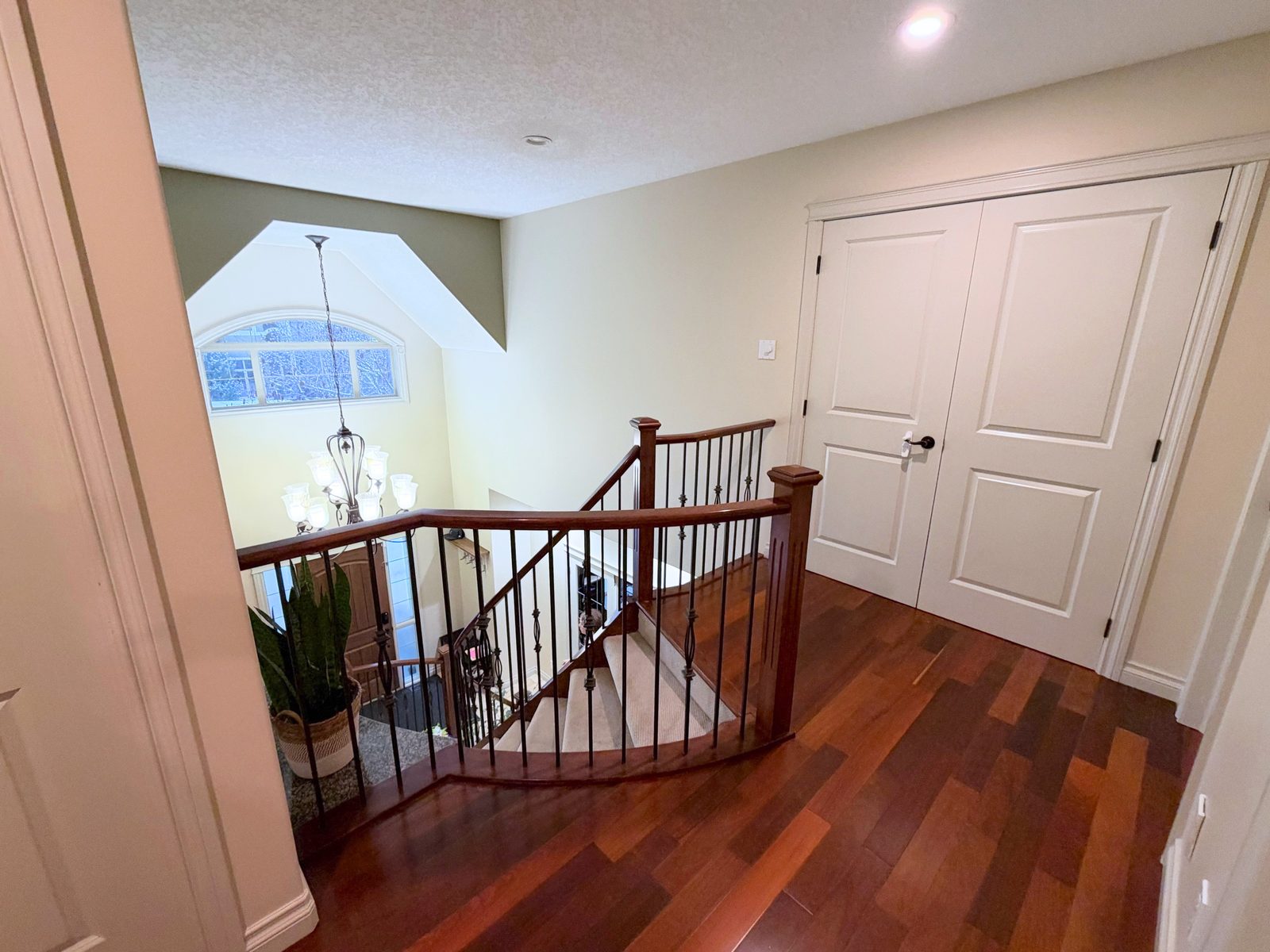 Upper landing overlooking the foyer and chandelier