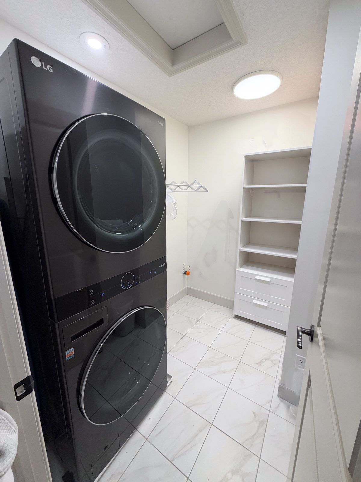 Laundry room with a stacked washer and dryer