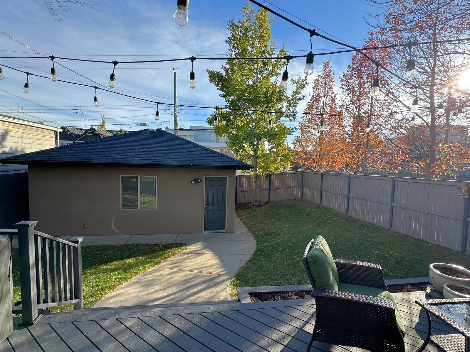 Fenced lawn and walkway from the deck to the detached garage