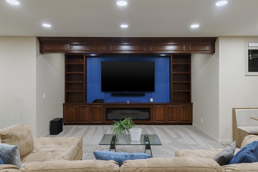 Built-in media wall with shelving and a fireplace