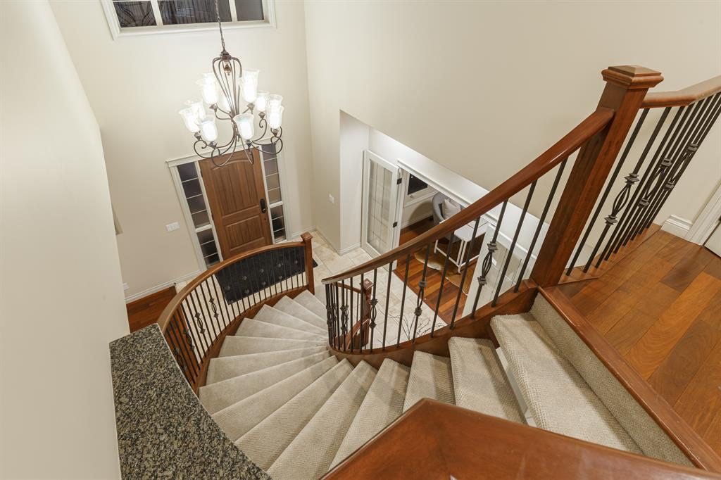 View down the curved staircase to the foyer