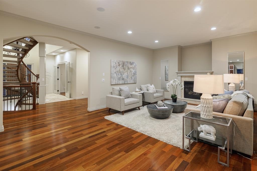 Family room with a gas fireplace and arched opening to the foyer
