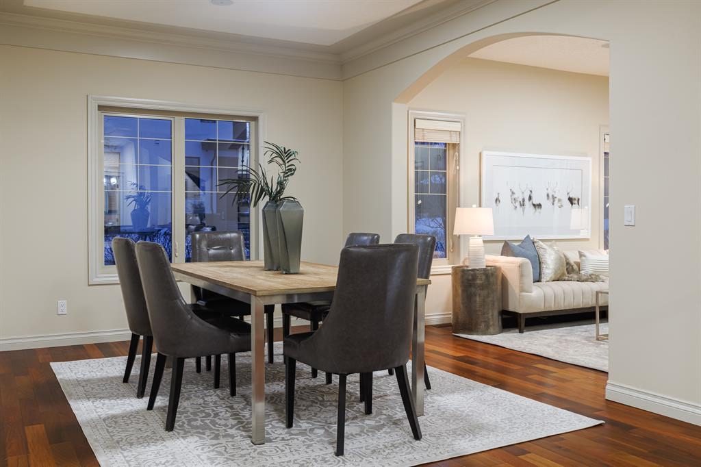 Dining room with a tray ceiling and crown moulding