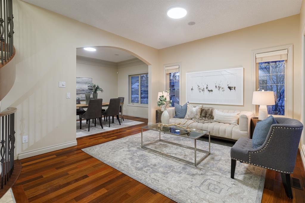 Living room with an arch through to the dining room